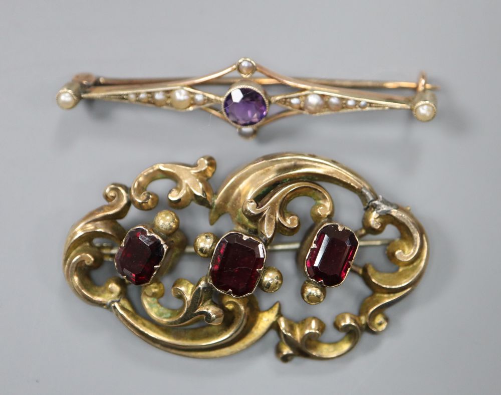 A 9ct gold, amethyst and seed pearl bar brooch, gross 2.9g and a Victorian pierced scrollwork brooch set with three garnets